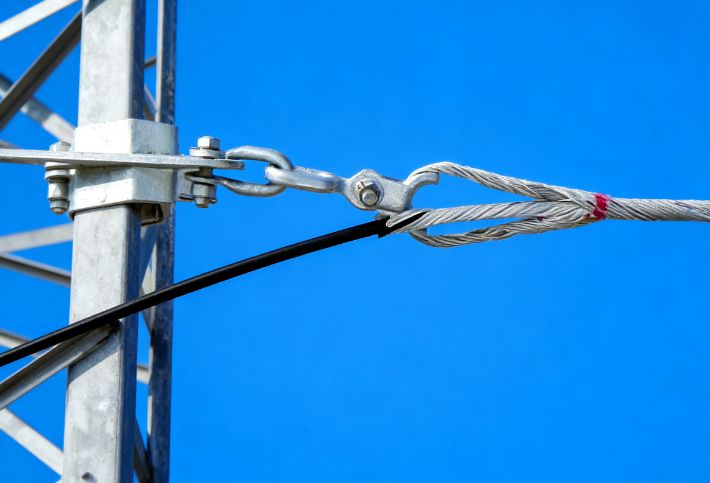 Preformed Helical Wrap Guy Grip Termination Providing Strain Relief and Enhanced Stability in Power Distribution Networks